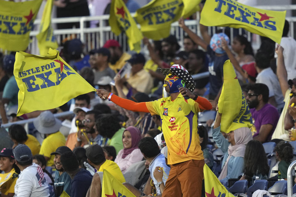 A fan in the stands cheers during a Major League Cricket match between the Los Angeles Knight Riders and the Texas Super Kings in Grand Prairie, Texas, Thursday, July 13, 2023. (AP Photo/LM Otero)