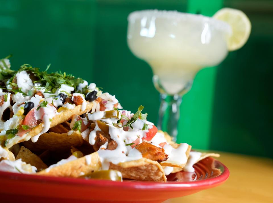 Signature nachos and a classic lime margarita on the rocks from Dos Hermanos' Easton restaurant