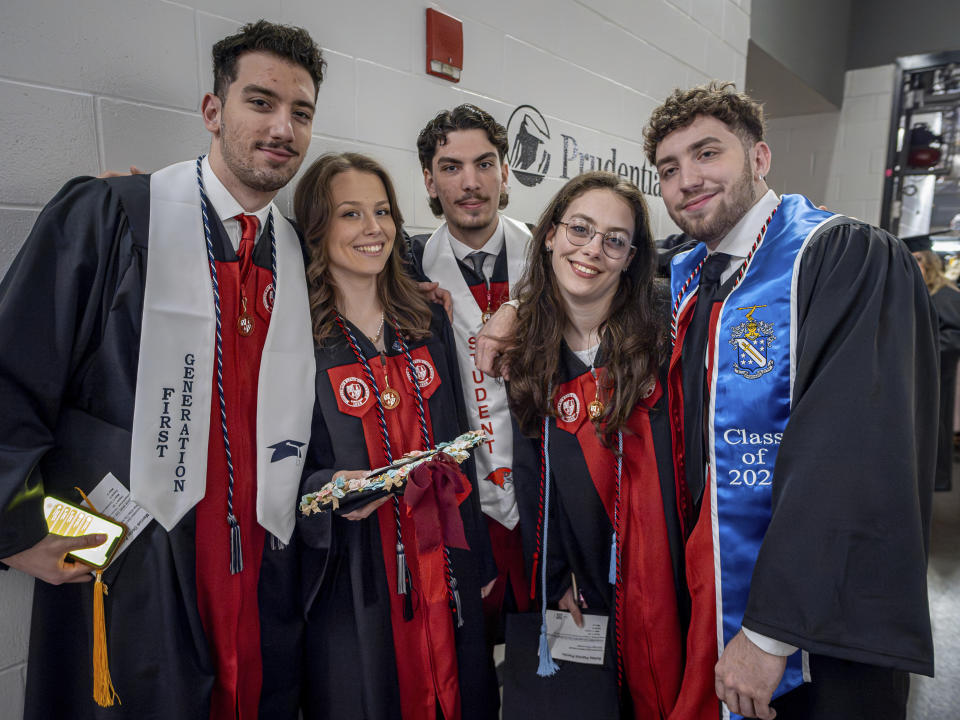 The Povolos quintuplets, from left; Marcus, Victoria, Michael, Ashley and Ludovico pose for a photo during the commencement ceremony at the Montclair State University, Monday, May 13, 2024, in Montclair, N.J. (Mike Peters/Montclair State University via AP)