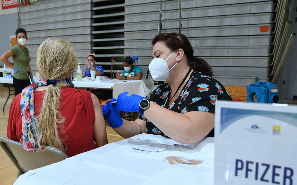 Nurse Jill Dortha administers a dose of the Pfizer COVID-19 vaccine to Karen Guerrina at a vaccination clinic at Winter Springs High School. As of September 10, 2021, 54% of Florida's population has been fully vaccinated. (Paul Hennessy/SOPA Images/LightRocket via Getty Images)