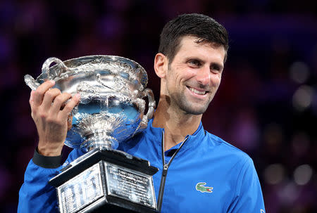 Tennis - Australian Open - Men's Singles Final - Melbourne Park, Melbourne, Australia, January 27, 2019. Serbia's Novak Djokovic poses with his trophy after winning the match against Spain's Rafael Nadal. REUTERS/Lucy Nicholson