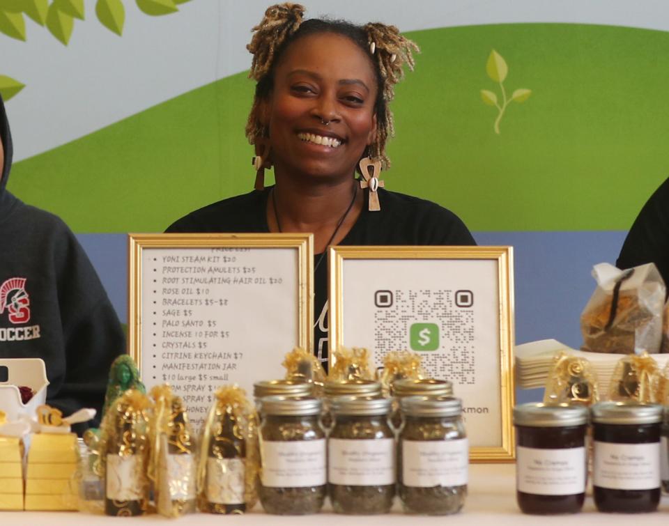 Tiffany Becton Blackmon owner of My Beehive AptheCare & More at her booth at the Summit Lake Neighborhood Farmer's Market. (Photo: Mike Cardew, Akron Beacon Journal)