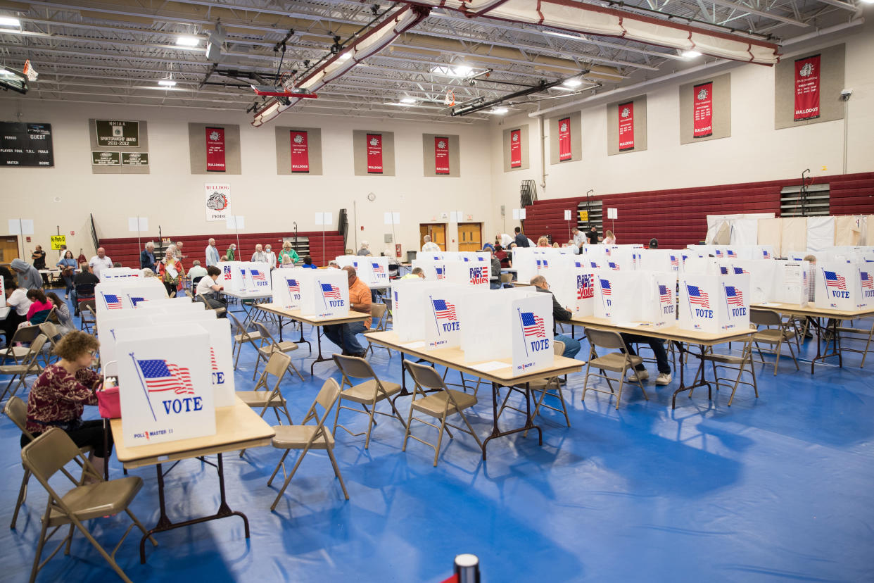Voters cast their ballots in the New Hampshire primary at Bedford High School, Sept. 13