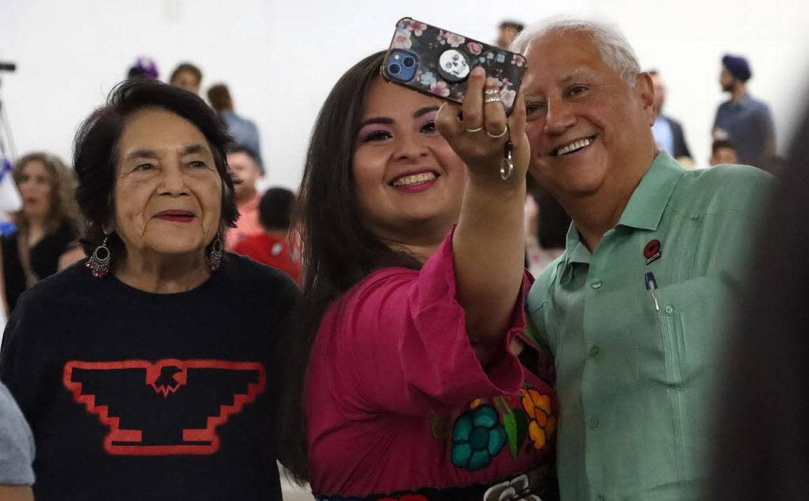 A woman takes a selfie with Dolores Huerta and Paul Chávez at the celebration of the renaming of Kings Canyon and two other streets in honor of farmworker icon César E. Chávez. The celebration took place at the Fresno fairgrounds on June 10, 2023.