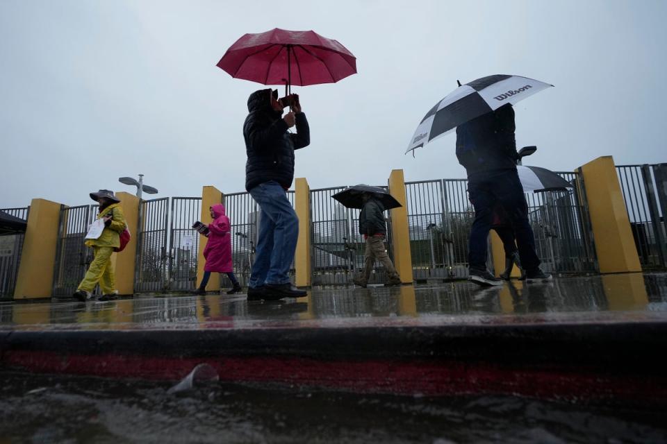 Los Angeles Unified School District, LAUSD teachers and Service Employees International Union 99 (SEIU) members strike during heavy rain outside the Edward R. Roybal Learning Center (AP)