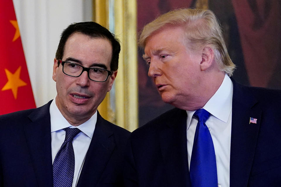 U.S. President Donald Trump stands with Treasury Secretary Steven Mnuchin prior to signing "phase one" of the U.S.-China trade agreement in the East Room of the White House in Washington, U.S., January 15, 2020. REUTERS/Kevin Lamarque?