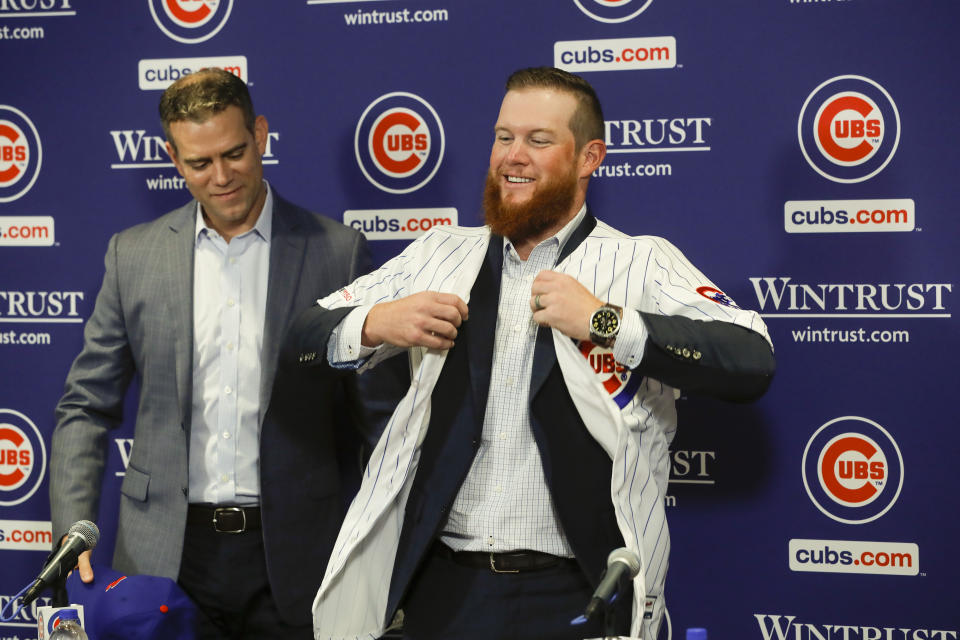 New Chicago Cubs pitcher Craig Kimbrel puts on his new jersey after being introduced by Chicago Cubs President Theo Epstein at Wrigley Field, Friday, June 7, 2019 in Chicago. (Jose M. Osorio/Chicago Tribune via AP)