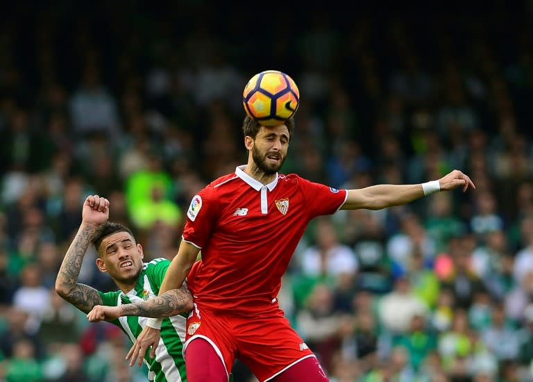 Betis's midfielder Felipe Gutierrez (L) vies with Sevilla's defender Nicolas Pareja (R) during the Spanish league football match February 25, 2017