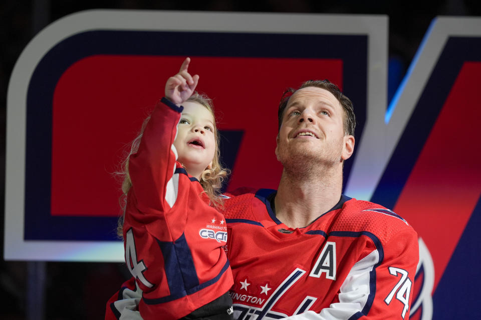 Washington Capitals defenseman John Carlson holds his son Sawyer Carlson during a ceremony to mark his playing in 1000 career NHL games before a hockey game against the Ottawa Senators, Sunday, April 7, 2024, in Washington. (AP Photo/Alex Brandon)