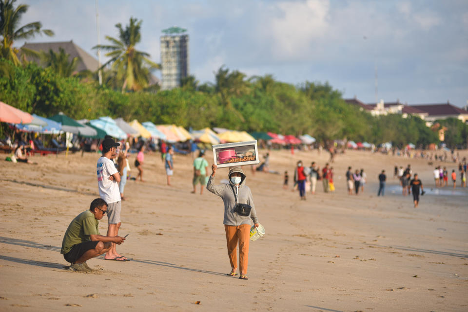 BADUNG, BALI, INDONESIA - 2021/06/14: A beach vendor carries her goods on her head at the beach.
Bali as one of the world tourism destination closed its international tourism since Covid-19 outbreak in 2020 and now it prepares to reopen for tourists this July 2021. (Photo by Dicky Bisinglasi/SOPA Images/LightRocket via Getty Images)