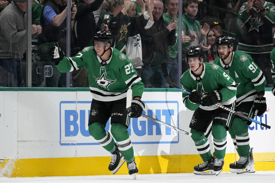 Dallas Stars' Mason Marchment (27), Nils Lundkvist (5) and Tyler Seguin (91) skate back to the bench after Marchment scored in the second period of an NHL hockey game against the Carolina Hurricanes in Dallas, Tuesday, Feb. 13, 2024. (AP Photo/Tony Gutierrez)