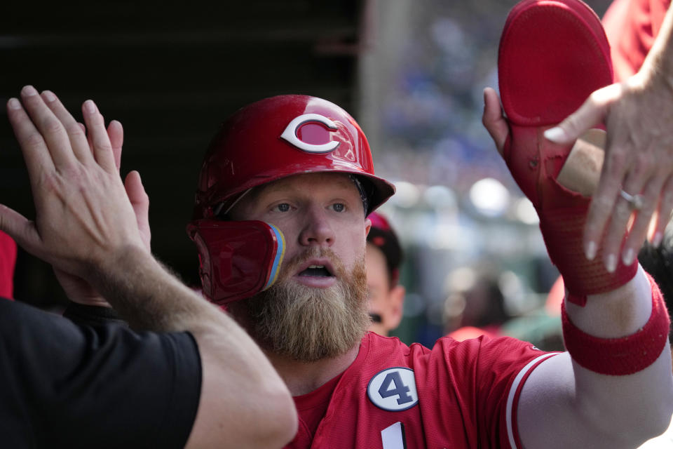 Cincinnati Reds' Jake Fraley celebrates with teammates after scoring on a sacrifice fly by Jonathan India during the second inning of a baseball game against the Chicago Cubs in Chicago, Sunday, June 2, 2024. (AP Photo/Nam Y. Huh)