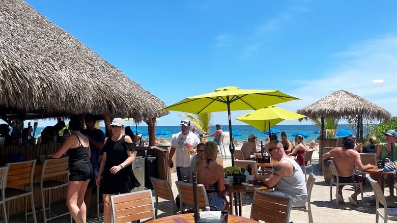 sunny day at beach tiki bar