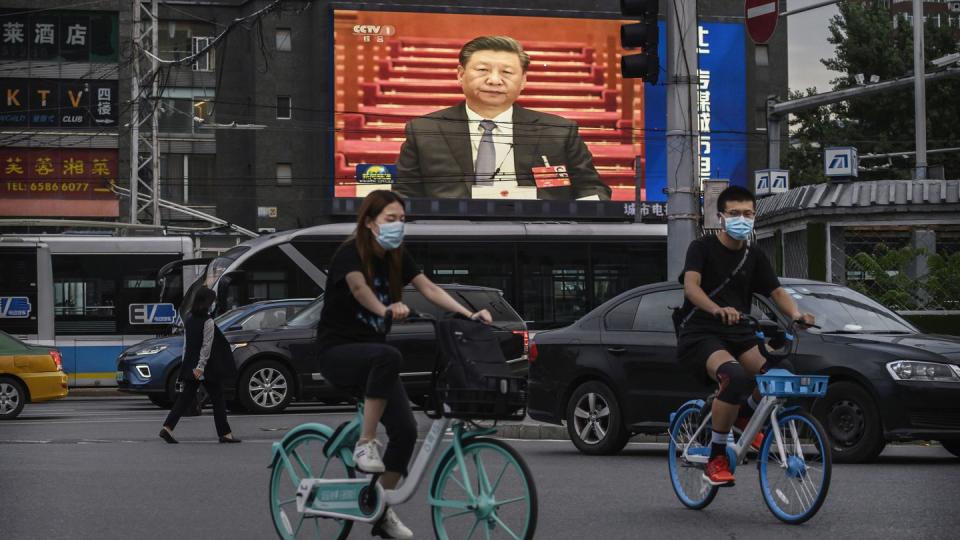 Chinese President Xi Jinping is seen on a screen showing the evening news in 2020 in Beijing. (Kevin Frayer/Getty Images)