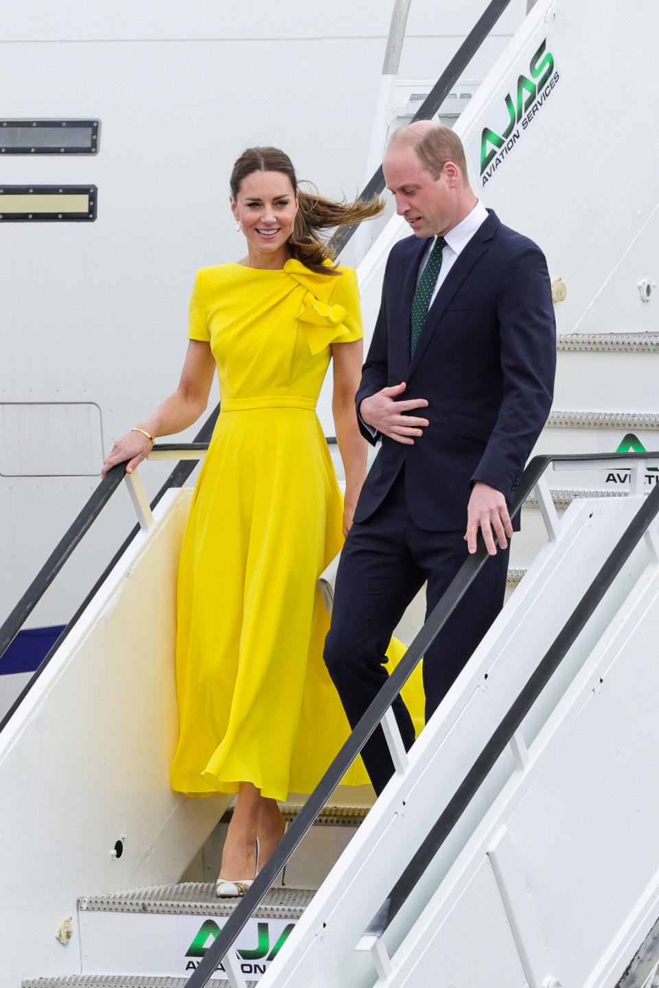 kate middleton in canary yellow dress walking down airplane steps, Kate Middleton and Prince William in Kingston, Jamaica during their eight-day tour of Jamaica and The Bahamas (Photo by Chris Jackson/Getty Images)