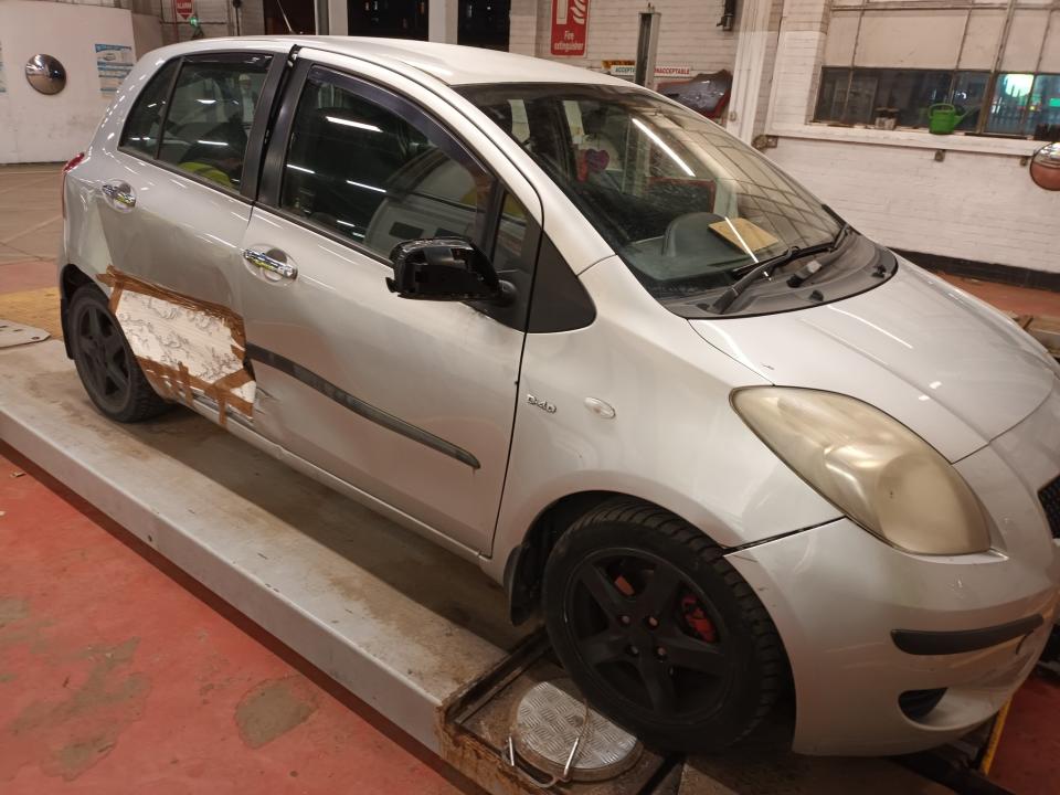 The Silver Toyota Yaris with wallpaper used to plug a hole in the bodywork. Photo released February 5 2024. See SWNS story SWMRpaper. A driver has been pulled over by police after fixing his smashed-up car – with wallpaper.Hilarious photos show how the motorist had used parcel tape and the flower-themed lining to hide a huge hole in the bodywork of his Silver Toyota Yaris hatchback.Stunned officers who spotted the baffling bodge job while checking vehicles in Bradford, West Yorks, called the car the “highlight of the evening”.They said the motor had previously been banned from driving by the Driving Standards Agency - and added that its owner was reported for its terrible condition.
