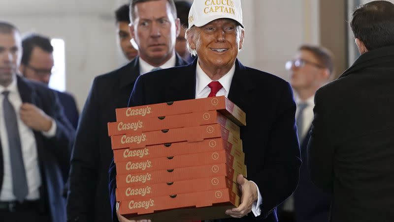 Republican presidential candidate former President Donald Trump arrives to deliver pizza to fire fighters at Waukee Fire Department in Waukee, Iowa, Sunday, Jan. 14, 2024. 