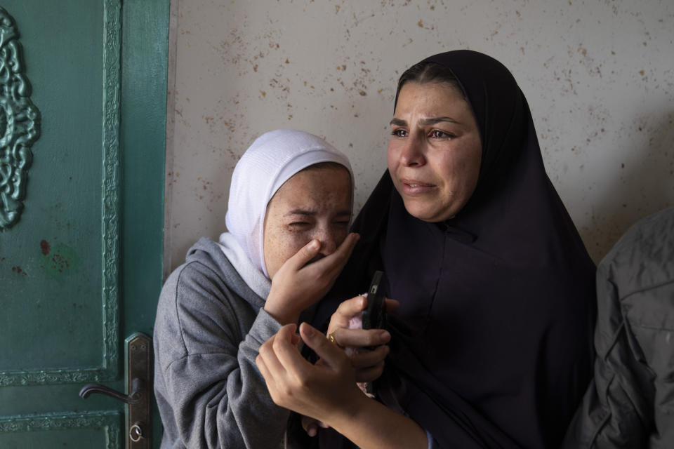 Mourners cry after taking the last look at the body of Palestinian Abdel Rahman Hamed, 18 during his funeral in the West Bank town of Silwad Monday, Jan. 29, 2024. Palestinian authorities say five Palestinians have been killed by Israeli forces in separate shootings across the occupied West Bank on Monday including Hamed who was killed during clashes with Israeli border police at his home village of Silwad. (AP Photo/Nasser Nasser)