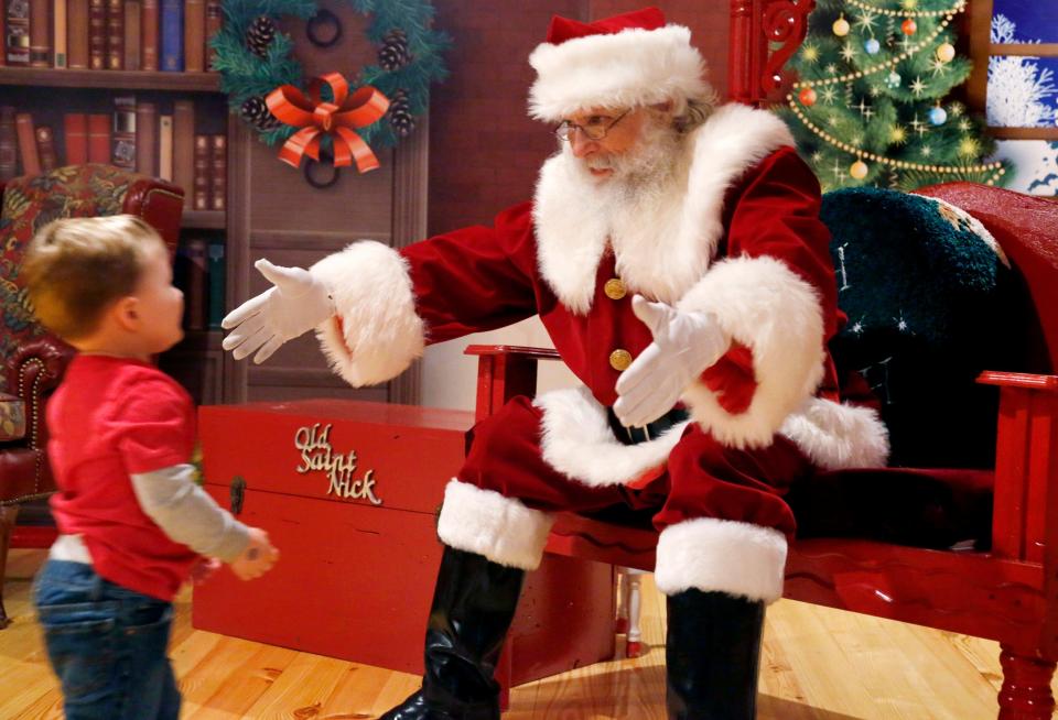 A young boy runs into the welcoming arms of Santa Claus at North Pole Adventure on Thursday, Dec. 8, 2016.