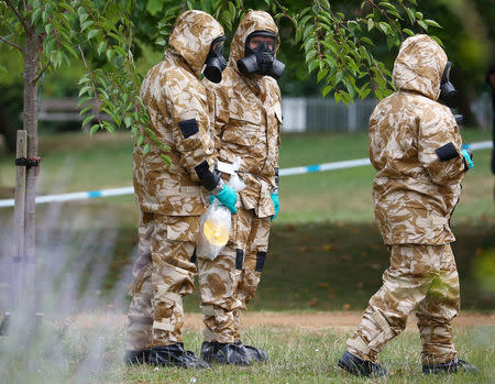 FILE PHOTO: People in military hazardous material protective suits collect an item in Queen Elizabeth Gardens in Salisbury, Britain, July 19, 2018. REUTERS/Hannah McKay/File Photo