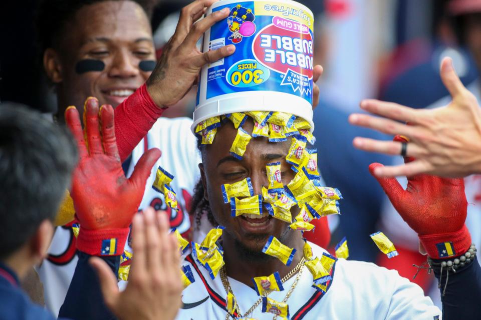 Ozzie Albies gets bubble gum dumped on his head after hitting a grand slam against the Pirates.