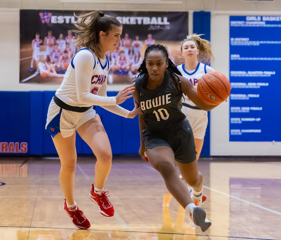 Bowie guard Micah Walton drives to the basket on Westlake's Lovie Bien during their game Jan. 2 at Westlake. Walton said she considers the Chaparrals to be Bowie's biggest rival.