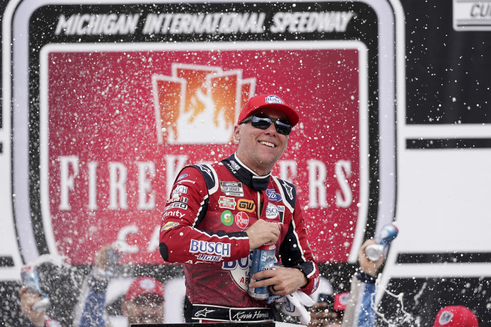 Kevin Harvick celebrates after winning the NASCAR Cup Series auto race at the Michigan International Speedway in Brooklyn, Mich., Sunday, Aug. 7, 2022. (AP Photo/Paul Sancya)