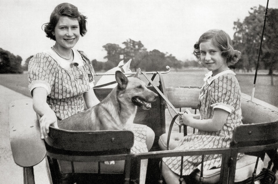 Princess Elizabeth, future Queen Elizabeth II, left, and Princess Margaret, right, driving a pony and trap in Great Windsor Park, England, 1941. Princess Margaret, Margaret Rose, 1930 – 2002, aka Princess Margaret Rose. Younger daughter of King George VI and Queen Elizabeth. Princess Elizabeth, future Elizabeth II, born 1926. Queen of the United Kingdom, Canada, Australia and New Zealand. From a photograph. (Photo by: Universal History Archive/Universal Images Group via Getty Images)