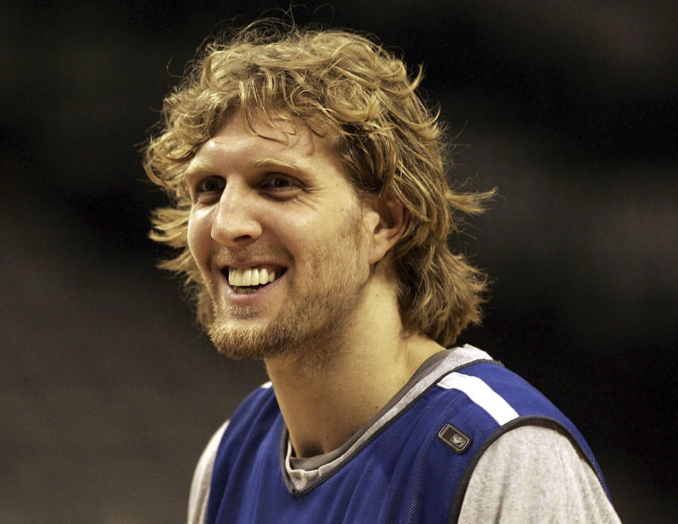 FILE - Dallas Mavericks' Dirk Nowitzki, of Germany, smiles during team basketball practice in Dallas, June 7, 2006. The Naismith Memorial Basketball Hall of Fame made it all official on Saturday, April 1, 2023 with three of the NBA’s all-time international greats — Nowitzki, Tony Parker and Pau Gasol — joining Dwyane Wade, Becky Hammon and Gregg Popovich as the headliners of the 2023 class that will be enshrined on Aug. 11 and 12 at ceremonies in Connecticut and Massachusetts. (AP Photo/LM Otero, File)