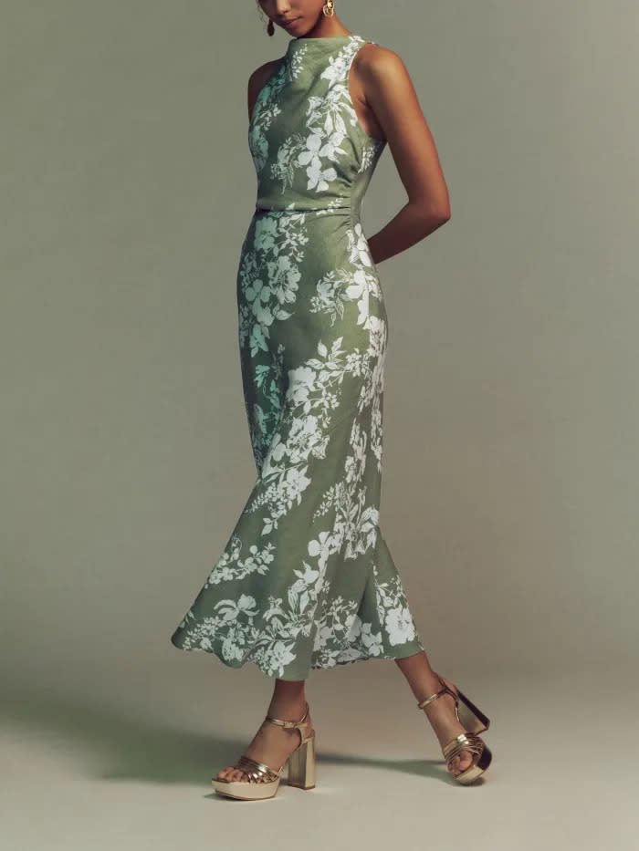 Model wears Reformation Casette Linen Dress in green floral print