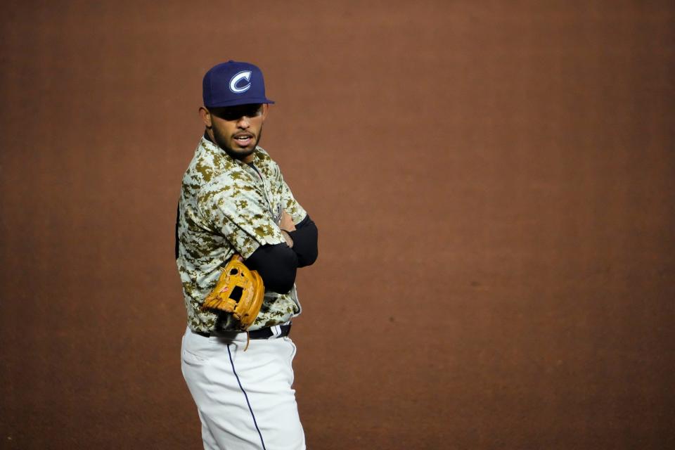 Columbus Clippers third baseman Gabriel Arias (13) crosses his arms to keep warm during the Minor League Baseball game against the Louisville Bats at Huntington Park in Columbus on April 27, 2022.