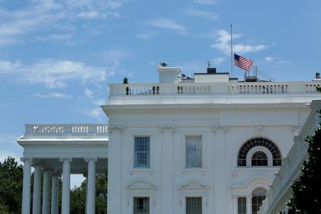 The U.S. flag is seen on half-staff to honor the victims of the Bastille Day truck attack in Nice, at the the White House in Washington, U.S. July 15, 2016. REUTERS/Yuri Gripas