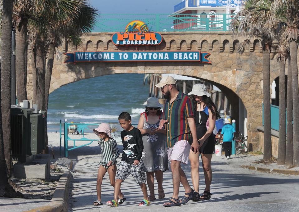 Visitors cross the Main Street beach ramp, Monday May 15, 2023 in Daytona Beach.