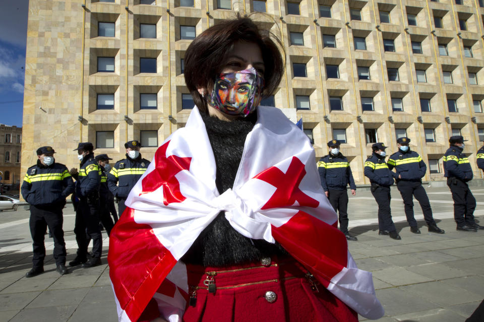 Georgian opposition supporter attends a rally following the detention of the United National Movement party leader Nika Melia, Tbilisi, Georgia, Tuesday, Feb. 23, 2021. Protesters denouncing the arrest of the head of Georgia's main opposition party have set up tents outside the country's parliament building and blocked the capital's main avenue. Tensions in Georgia have been strong since the October parliamentary election that the opposition is demanding be rerun. (AP Photo/Shakh Aivazov)