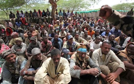 FILE PHOTO: Members of Somalia's al-Qaeda linked al Shabaab militia are paraded at Maslah square after their surrender to the authorities in the north of Mogadishu, Somalia September 24, 2012. REUTERS/Omar Faruk/File Photo