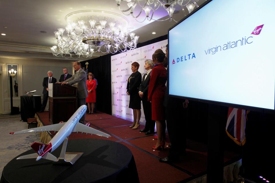 Delta Chief Executive Richard Anderson speaks on stage as Virgin Atlantic employees watch during a news conference in New York on December 11, 2012, to announce Delta Air Lines is buying Singapore Airlines' 49 percent stake in Virgin Atlantic for $360 million.