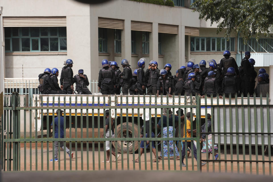 Riot police stand on a police truck while waiting for Zimbabwean opposition figure Job Sikhala to arrive at the magistrates courts in Harare, Wednesday, Jan, 24. 2024. A Zimbabwean court is expected to give judgment Wednesday on Sikhala who spent nearly two years in pretrial detention on political charges. (AP Photo/Tsvangirayi Mukwazhi)