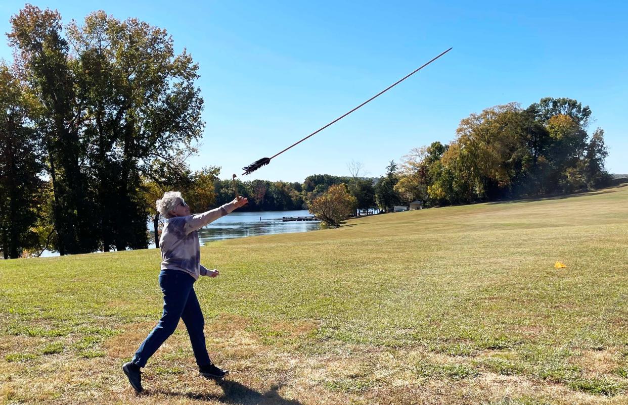 Becky Rushton tries spear throwing at the John Knox Center (JKC). An Oak Ridge Institute for Continued Learning class learned about the Yuchi tribe that lived in Oak Ridge and built mounts preserved by the JKC.