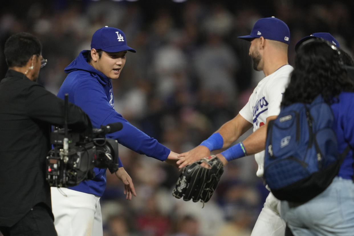 Los Angeles Dodgers designated hitter Shohei Ohtani celebrates with outfielder Kevin Kiermaier, right, after a 6-4 win over the Colorado Rockies in a baseball game in Los Angeles, Friday, Sept. 20, 2024. (AP Photo/Ashley Landis)