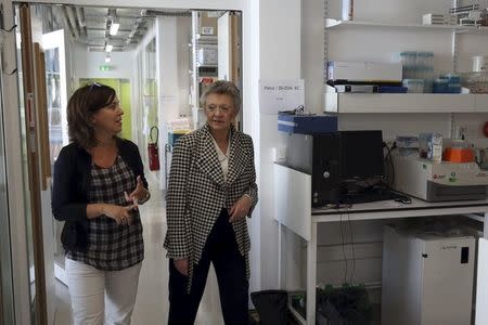 French virologist and director of the Regulation of Retroviral Infections Division (Unite de Regulation des Infections Retrovirales) at the Institut Pasteur in Paris Francoise Barre-Sinoussi (R) speaks with associate professor HIV, Head Virology Department Michaela Muller-Trutwin following an interview with Reuters, in Paris, France, October 1, 2015. REUTERS/Philippe Wojazer