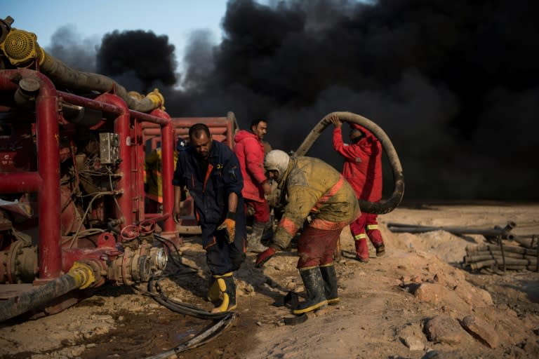 IS fighters set the fields ablaze to slow government forces advancing on Qayyarah as part of their drive to wrest back Mosul from the clutches of the jihadists