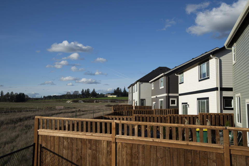 Homes are seen on Thursday, Feb. 22, 2024, in the southwest Portland, Ore., suburb of Beaverton. The so-called urban growth boundary, established by a 1973 law that placed boundaries around cities to prevent urban sprawl and preserve nature and farmland, is seen in the background along SW Tile Flat Road. (AP Photo/Jenny Kane)