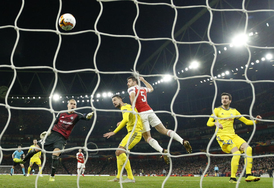 Arsenal's Sokratis Papastathopoulos, second right, scores his side's third goal during the Europa League round of 32 second leg soccer match between Arsenal and Bate at the Emirates stadium in London, Thursday, Feb. 21, 2019. (AP Photo/Matt Dunham)