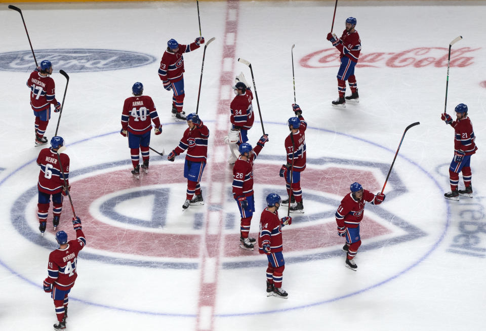 Montreal Canadiens players salute the fans after defeating the Toronto Maple Leafs 3-2 in overtime in Game 6 of an NHL hockey Stanley Cup first-round playoff seres Saturday, May 29, 2021, in Montreal. (Ryan Remiorz/The Canadian Press via AP)