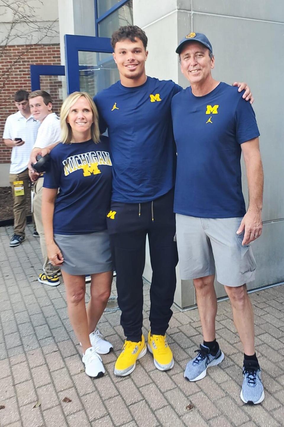 2022 with the firefighter, Tom Broyles, who saved his life. Tom's wife is on the left. courtesy of Erick's mother, Kelly All