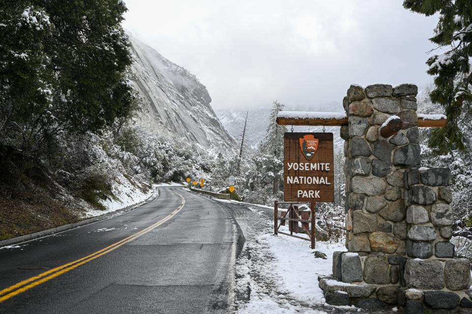 A welcome sign is seen as snow blankets Yosemite National Park in California, United States on February 23, 2023