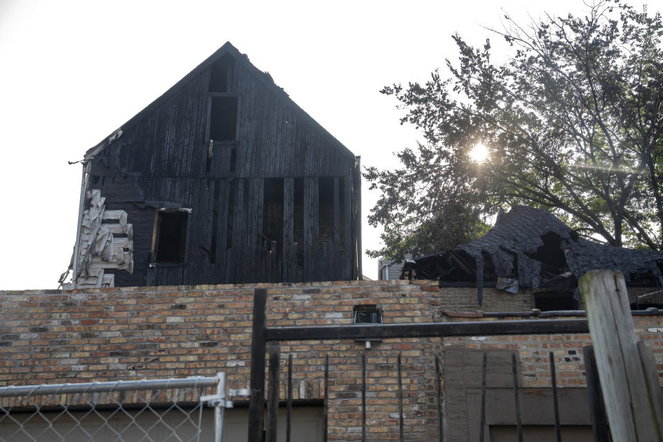 This Sunday, Aug. 26, 2018, photo shows damaged buildings at the scene of a fatal fire that killed several people including multiple children in Chicago. (Erin Hooley/Chicago Tribune via AP)