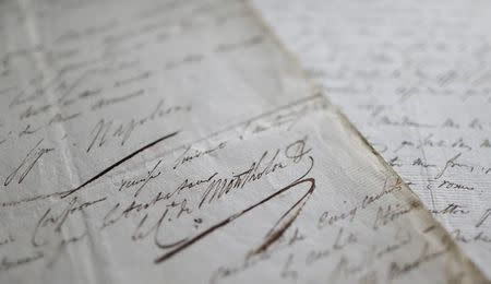 The signature reading "Napoleon" (top) written by the aide of late French Emperor Napoleon weeks before his death is seen on documents coming from a private collection of eight codicils dictated by the incapacitated Emperor and displayed in Paris, September 26, 2013. REUTERS/Christian Hartmann