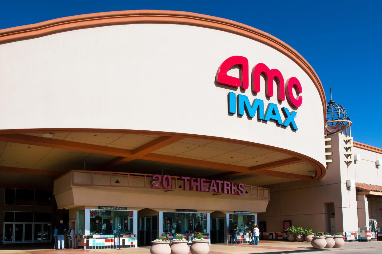 Front exterior of an AMC IMAX Movie Theater in Sunnyvale, California with ticket purchasing area against a vivid blue sky