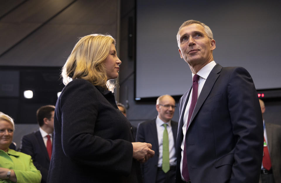 NATO Secretary General Jens Stoltenberg, right, speaks with British Defense Minister Penny Mordaunt during a meeting of NATO defense ministers at NATO headquarters in Brussels, Wednesday, June 26, 2019. (AP Photo/Virginia Mayo)